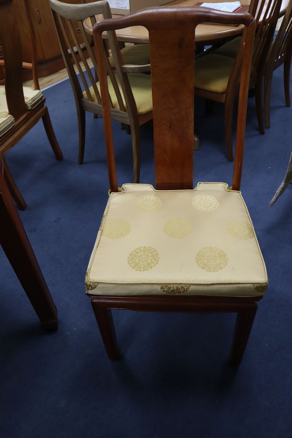 A Chinese hardwood dining table, 234cm extended (three spare leaves), width 112cm, height 76cm and eight chairs